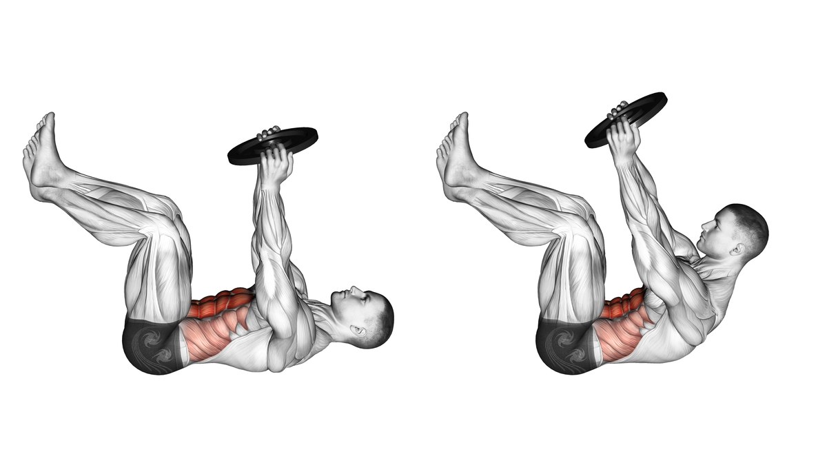 Two side views of a man performing a floor crunch with a weight plate held above his chest. His knees are bent and his feet raised in both frames. On the left his upper back rests down; on the right his head and shoulder blades curl up while his pelvis stays down. The front and sides of the abdomen are highlighted in red.